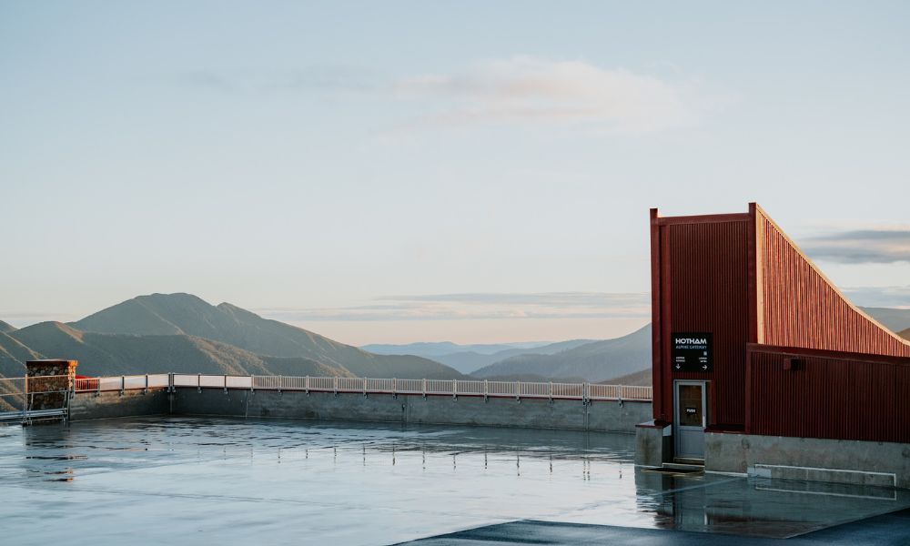 Water holding area that looks over apline mountains.